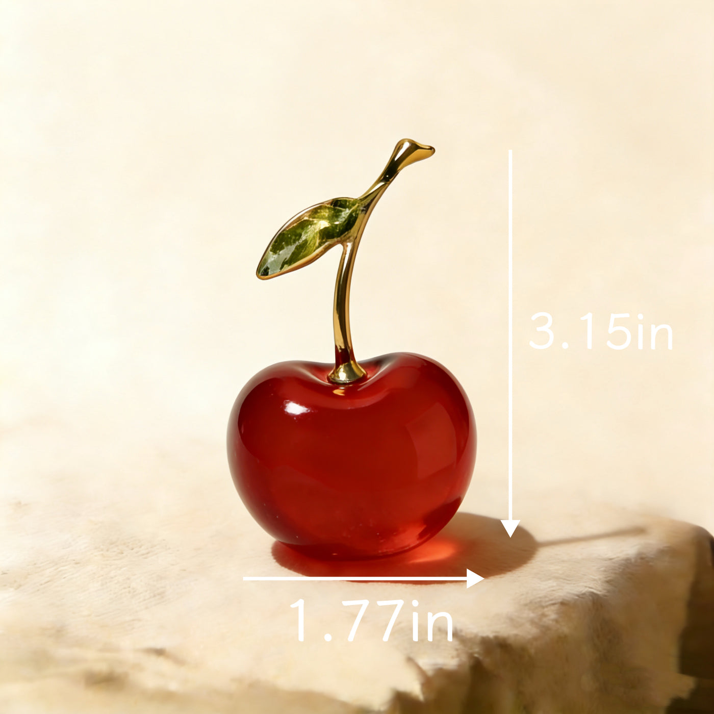 Ruby red glass cherry ornament shown at an angle, light passing through the translucent body