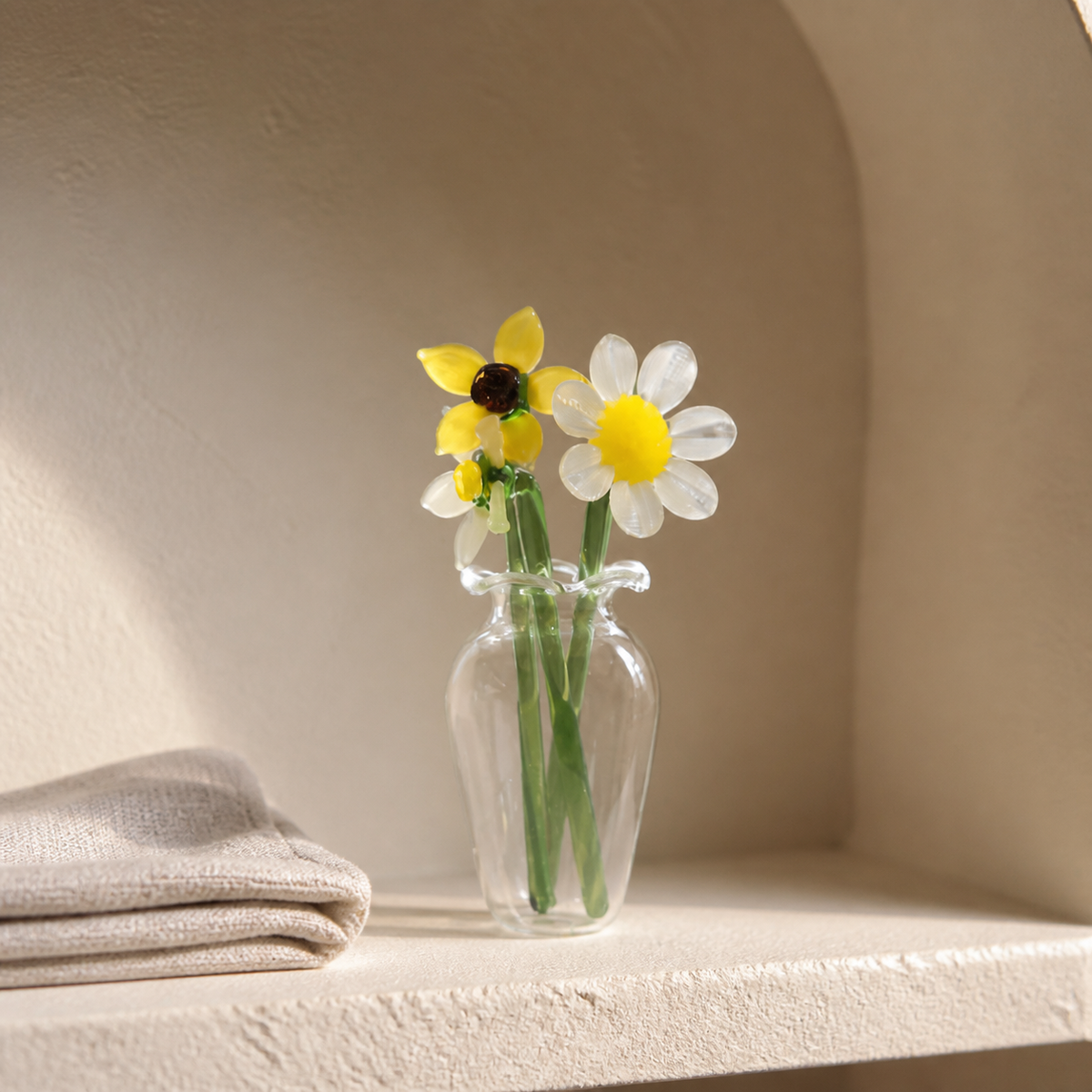 Yellow and white miniature glass flowers in a curved shelf niche