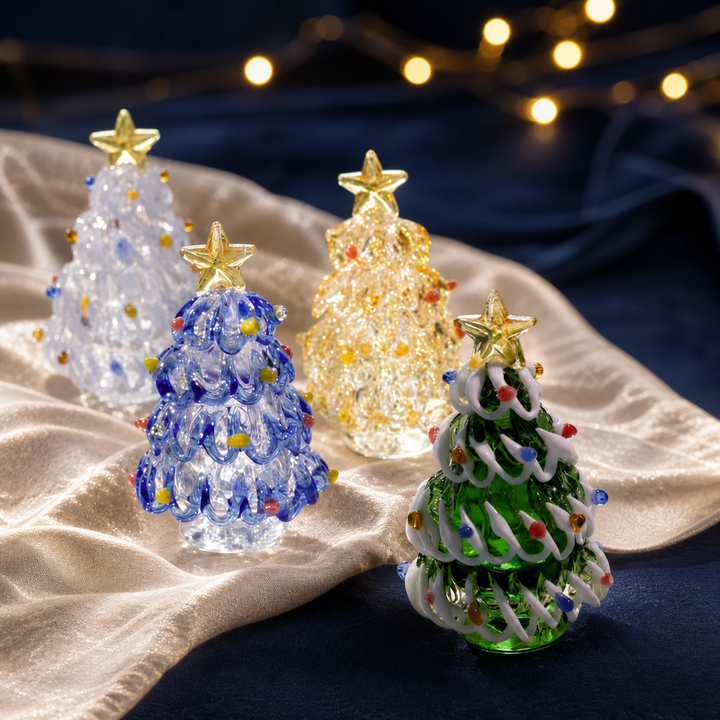 Five handmade glass Christmas tree figurines with gold stars in an elegant holiday setting