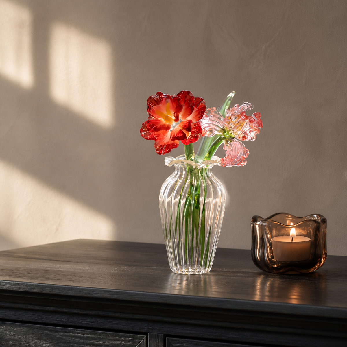 Red and pink miniature glass flowers on a dark dining console