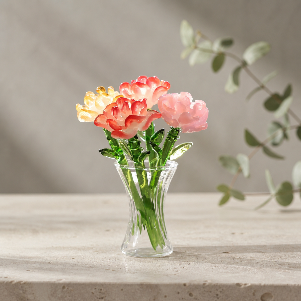 Red pink and yellow handmade glass carnation bouquet in a clear flared vase