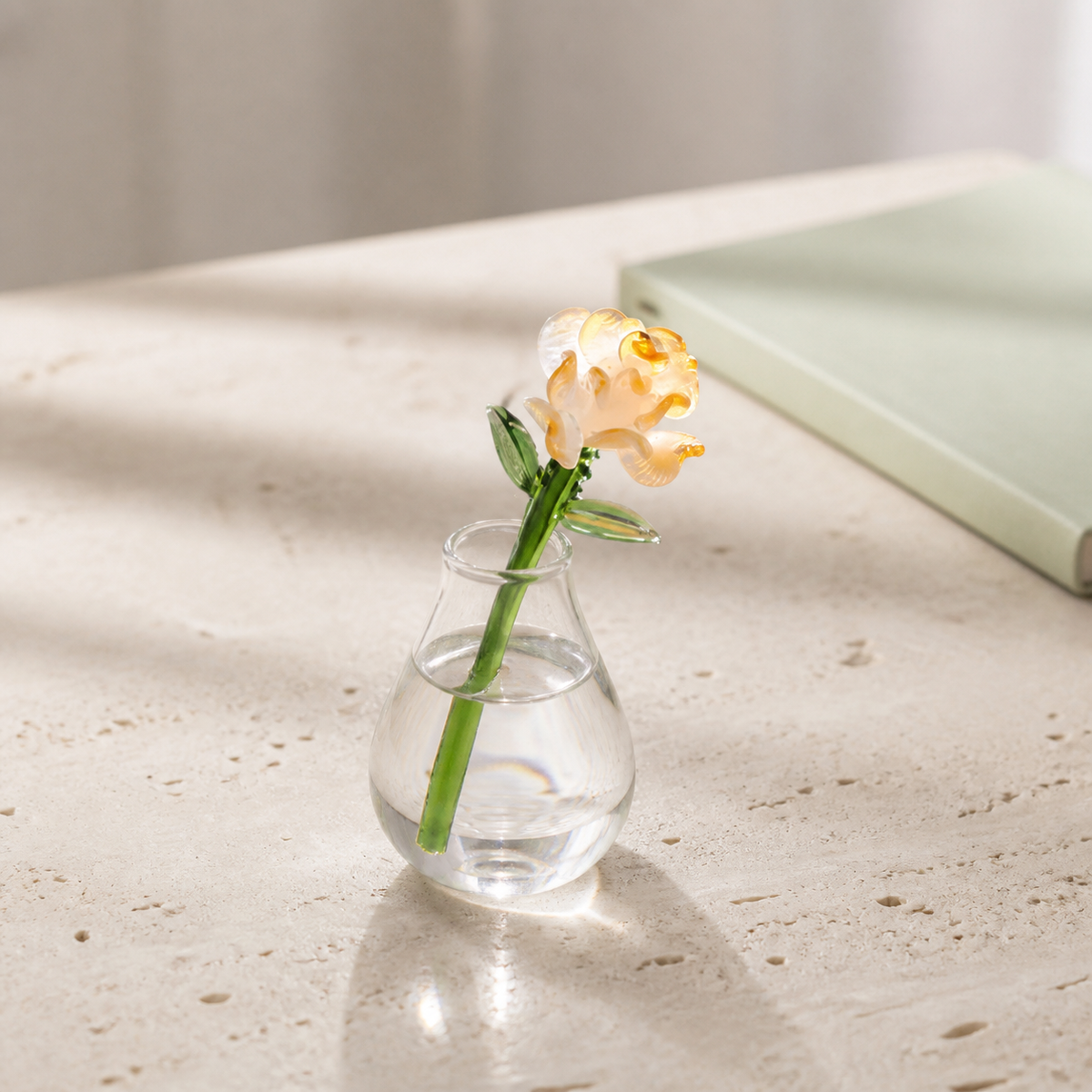 Yellow handmade glass carnation displayed in a small clear vase