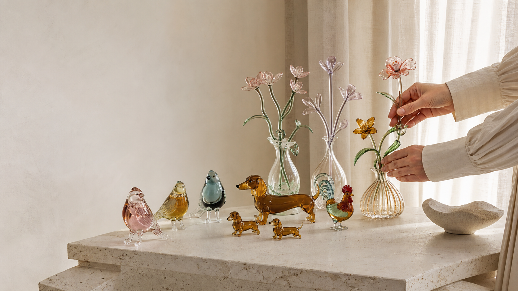 Handmade glass flowers and animal figurines in a warm modern interior